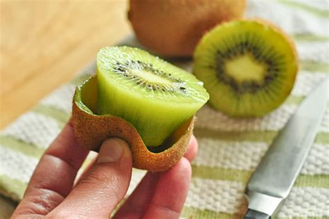 One of the easiest ways to cut and eat a kiwi fruit (and one of our personal favorites) takes less than a few seconds and requires a spoon as well as a knife. Simply grab your ripe kiwi fruit. Slice the kiwi fruit in the middle so you are left with equal halves. Grab a small spoon (a teaspoon works well, as does a grapefruit spoon) and scoop ...